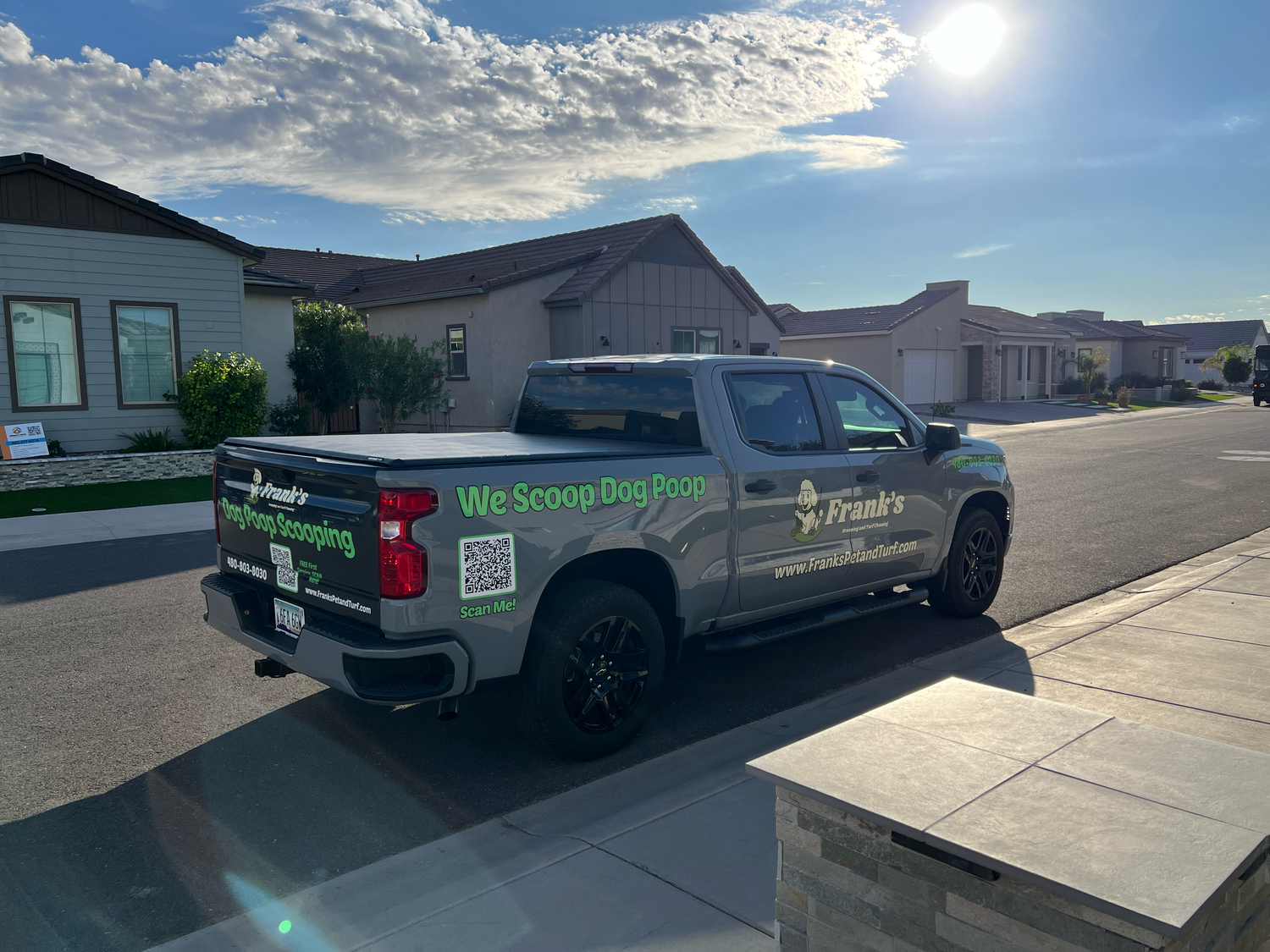 Truck with Frank's Pet Waste Management branding parked on a residential street.